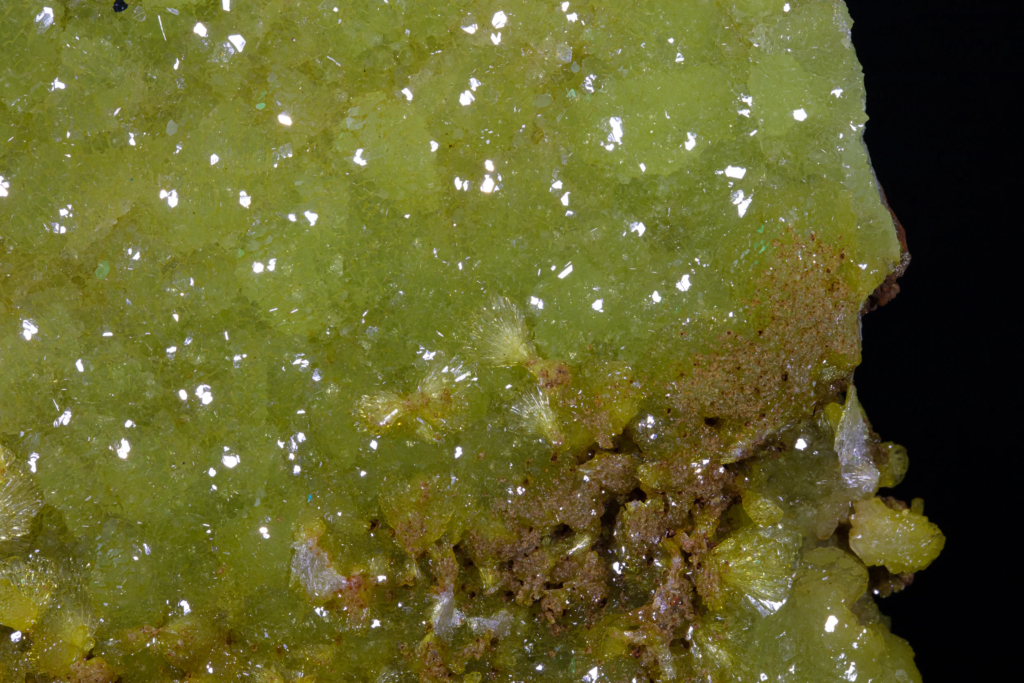 Micro photograph showing green adamite crystals on a brown matrix from Mexico.