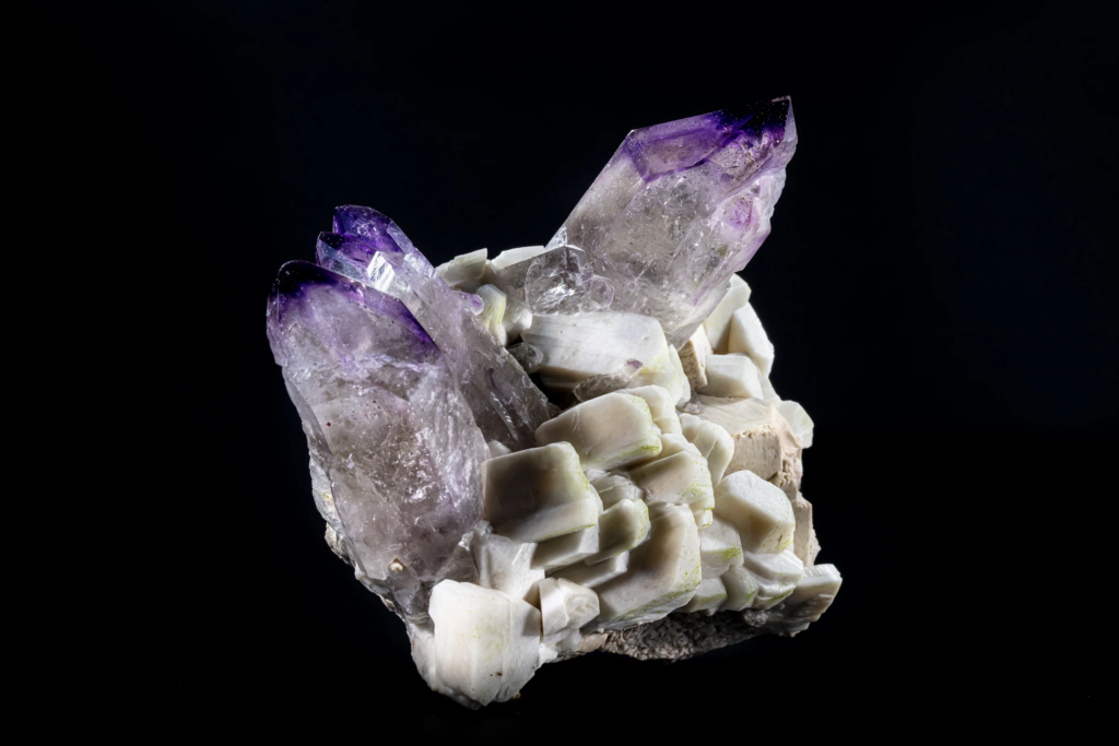 Purple-tipped amethyst crystals on white blocky feldspar matrix from Namibia.