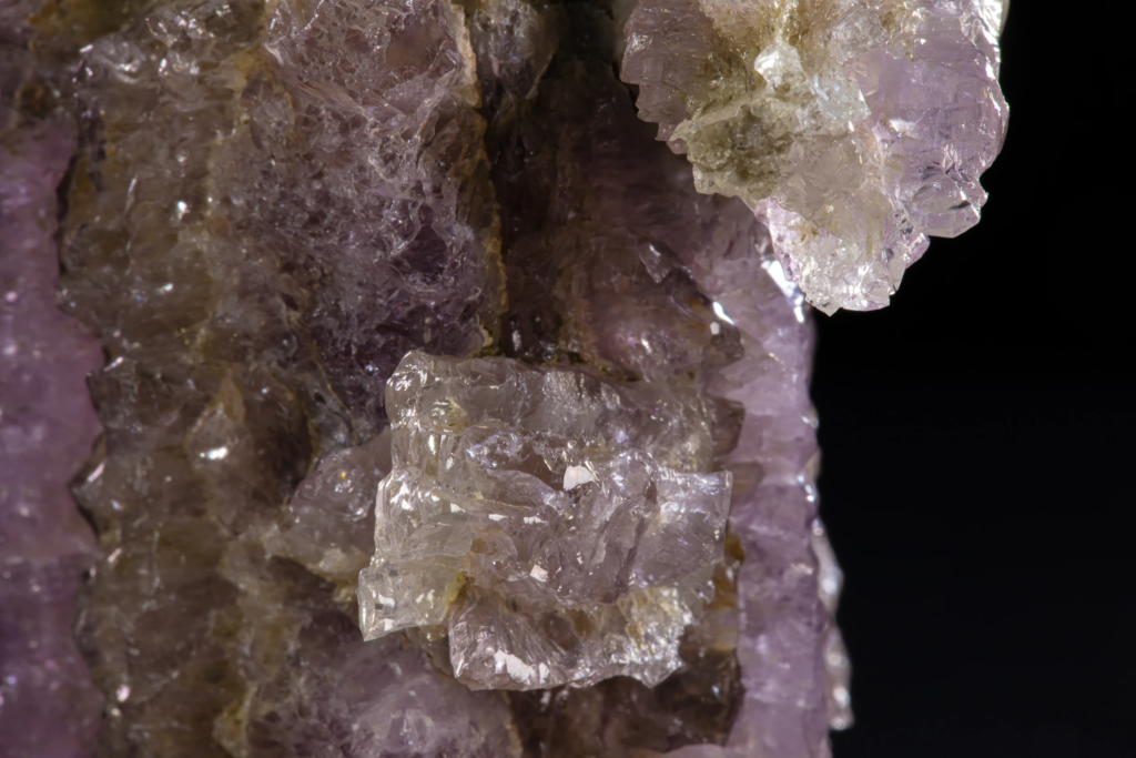 Detailed macro of purple aragonite crystal faces showing vitreous luster.