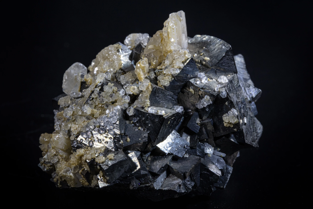 Metallic gray arsenopyrite crystals from Kosovo showing striated prismatic faces.