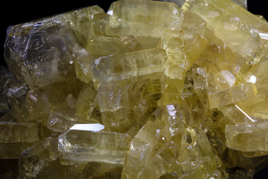 Micro detail of golden yellow prismatic barite crystals from the USA.