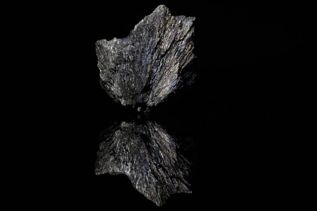 Metallic gray radiating berthierite specimen with a sharp bottom reflection.