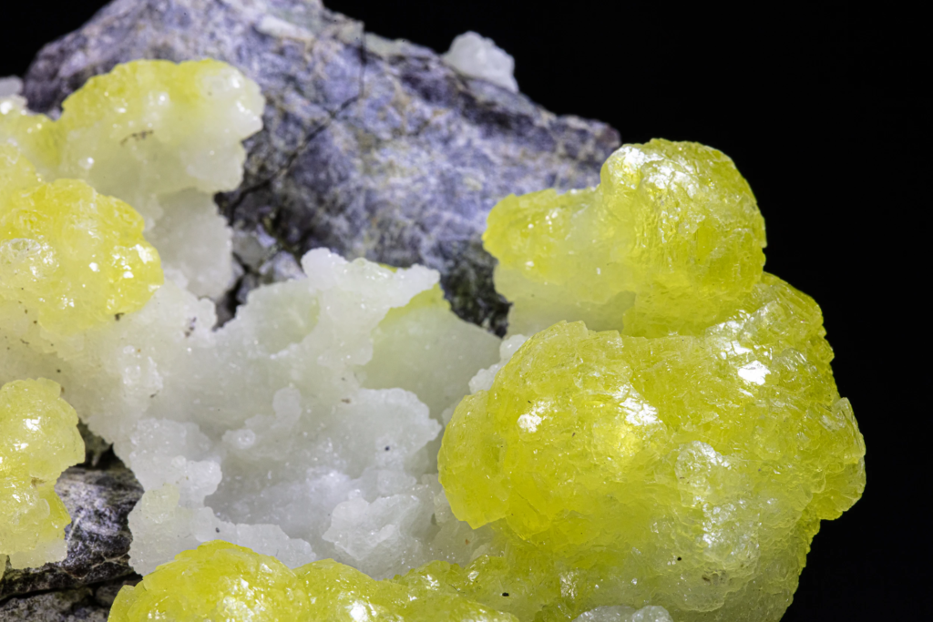 Rounded yellow brucite mass on gray host rock, Pakistan.