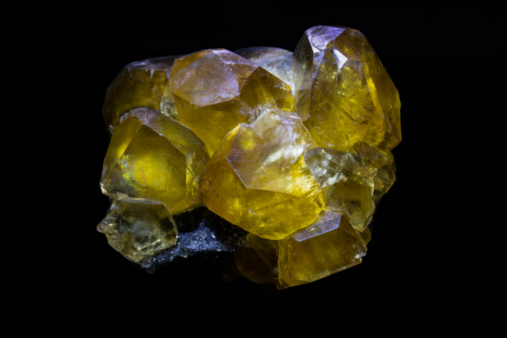 Translucent yellow calcite crystals from China on a dark matrix.