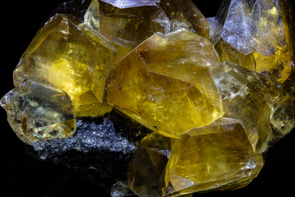 Macro of yellow calcite crystal faces from China with surface iridescence.