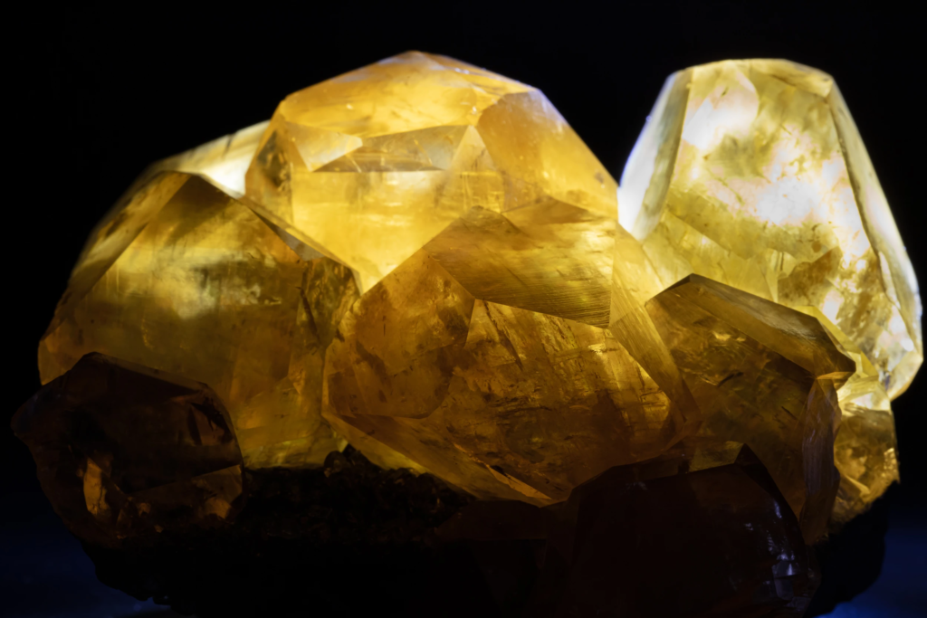 Macro detail of backlit translucent yellow calcite crystal planes from China.