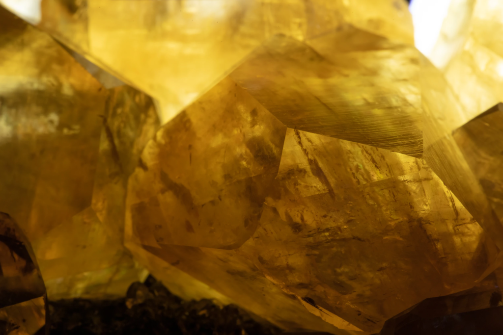 Complete cluster of yellow calcite crystals from China on dark matrix.