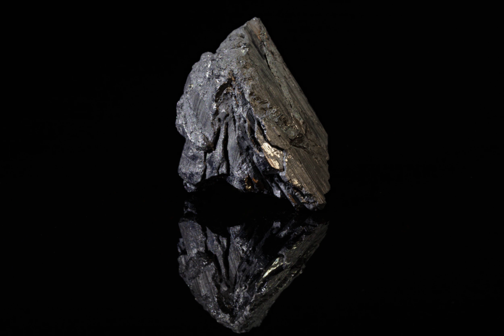 Metallic steel gray striated andorite crystal from Bolivia with reflection.