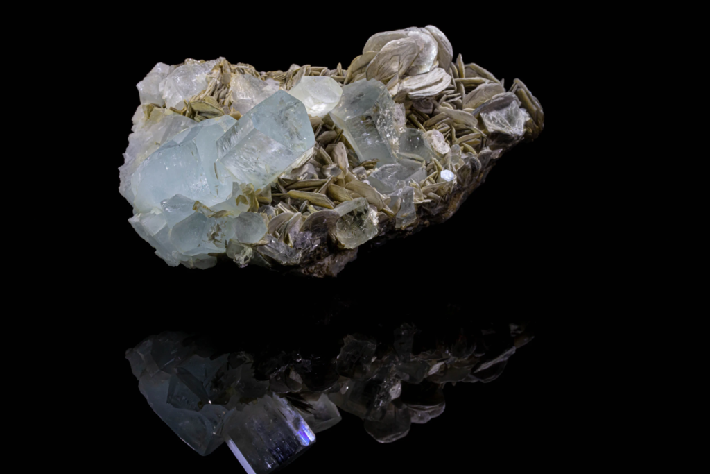 Pale blue aquamarine crystal with silvery muscovite rosettes from Pakistan.