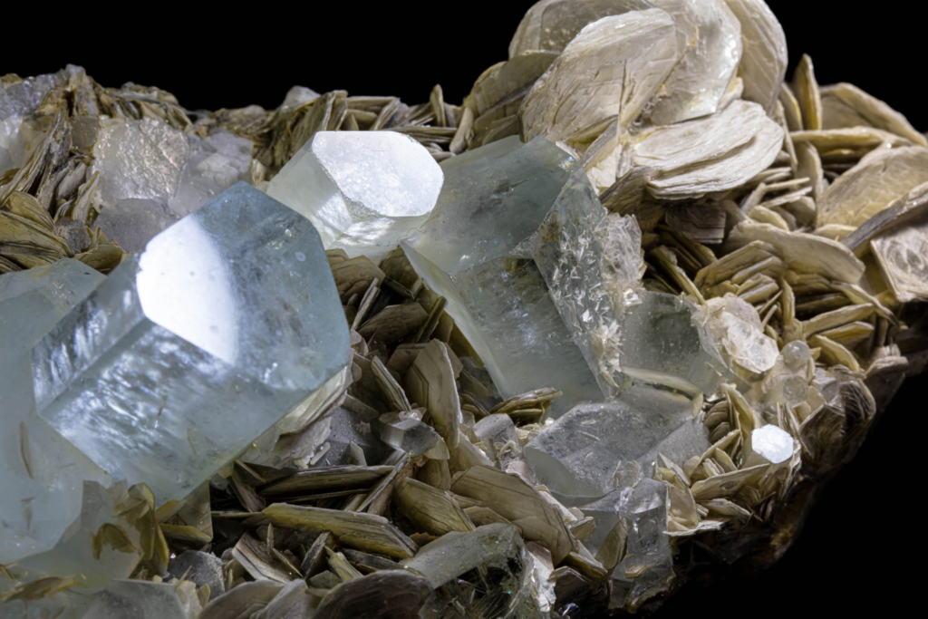 Angled macro of a silvery muscovite rosette on pale blue aquamarine, Pakistan.