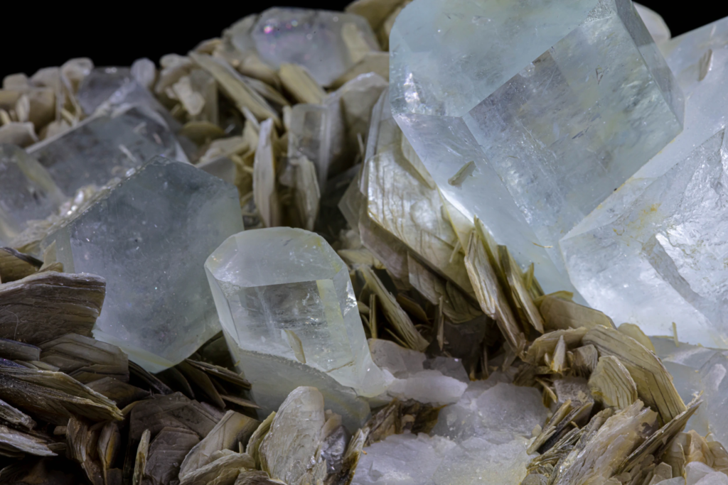 Medium shot of transparent blue aquamarine crystals embedded in pakistani muscovite.