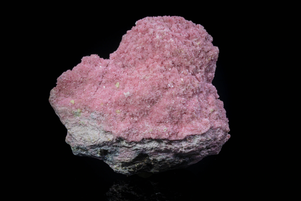 Close-up of sharp brown axinite crystals on pink rhodonite from Peru.