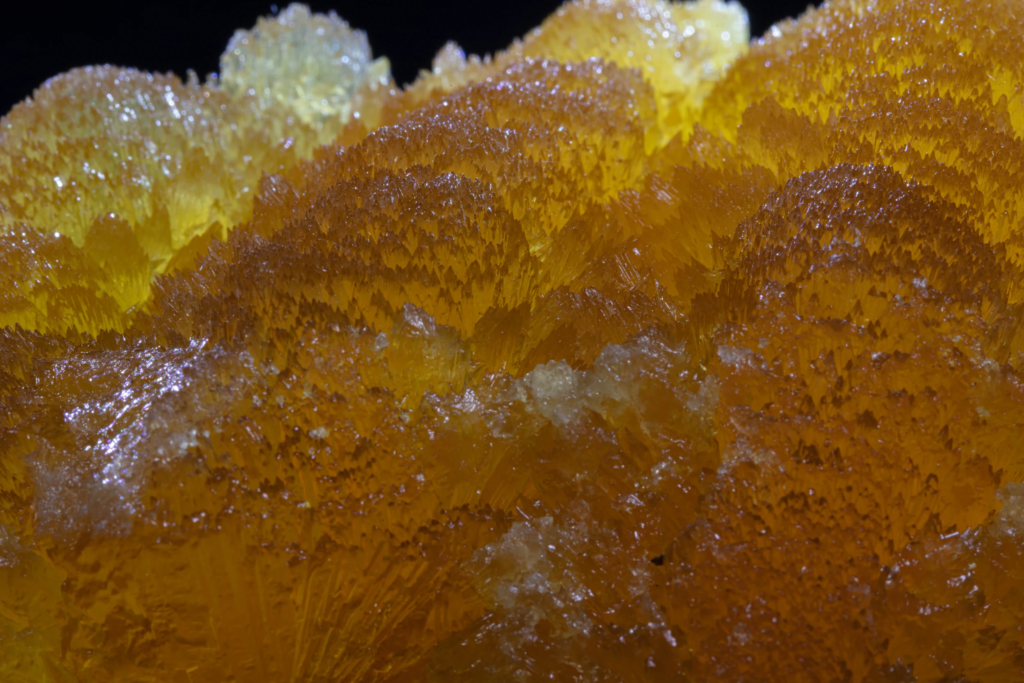Macro photograph of microscopic yellow calcite crystal terminations from France.