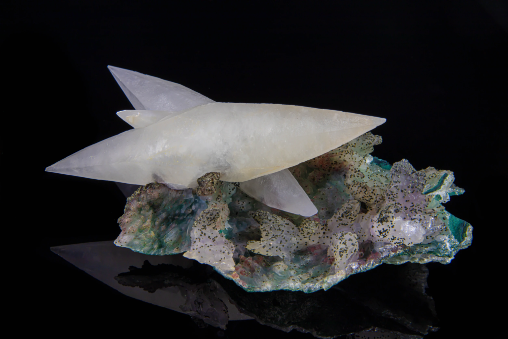Reversed view of translucent white calcite crystals on matrix from Brazil.