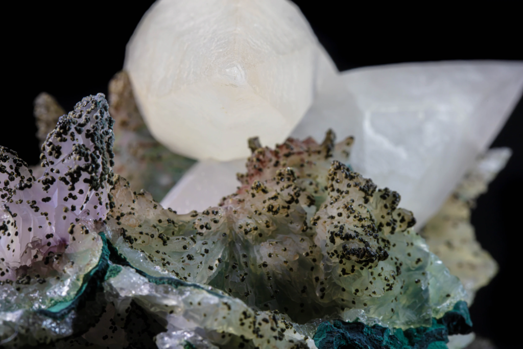 Macro detail of white calcite crystal contact with mineralized matrix, Brazil.