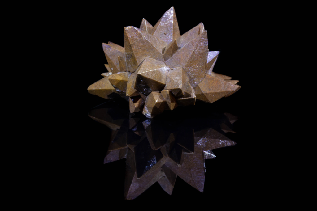 Brown scalenohedral calcite crystal cluster from Mexico with mirror reflection.