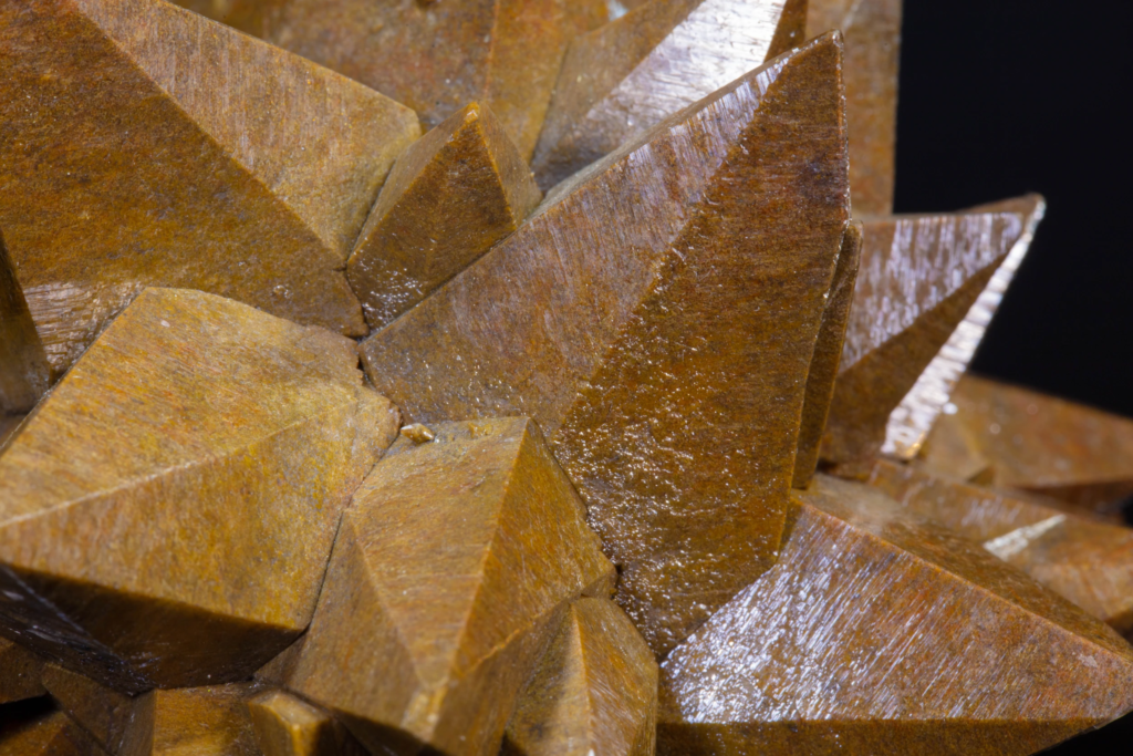 Macro photograph of striated faces on brown calcite crystals, Mexico.