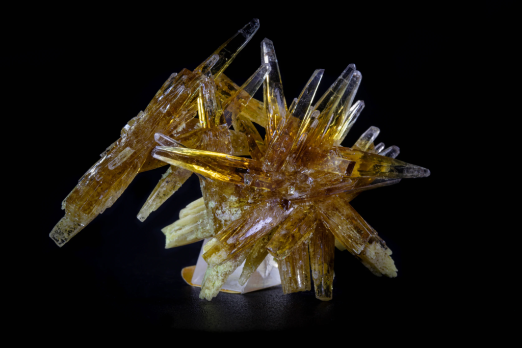 Honey yellow prismatic celestine crystal cluster from Poland against a black background.