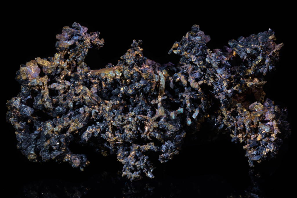 Close full view of dendritic native copper with dark cuprite crystals.