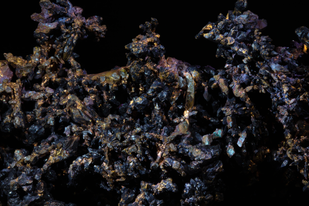 Close-up of jagged native copper spires and dark cuprite crystals.