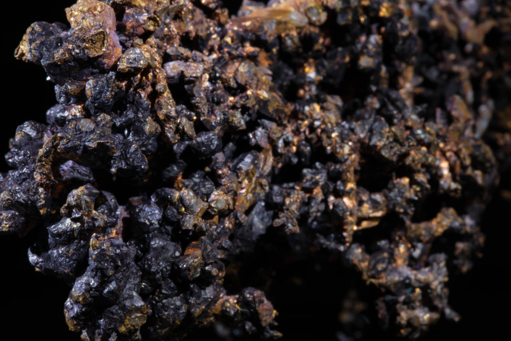 Macro view of branching native copper structures and dark cuprite aggregates.