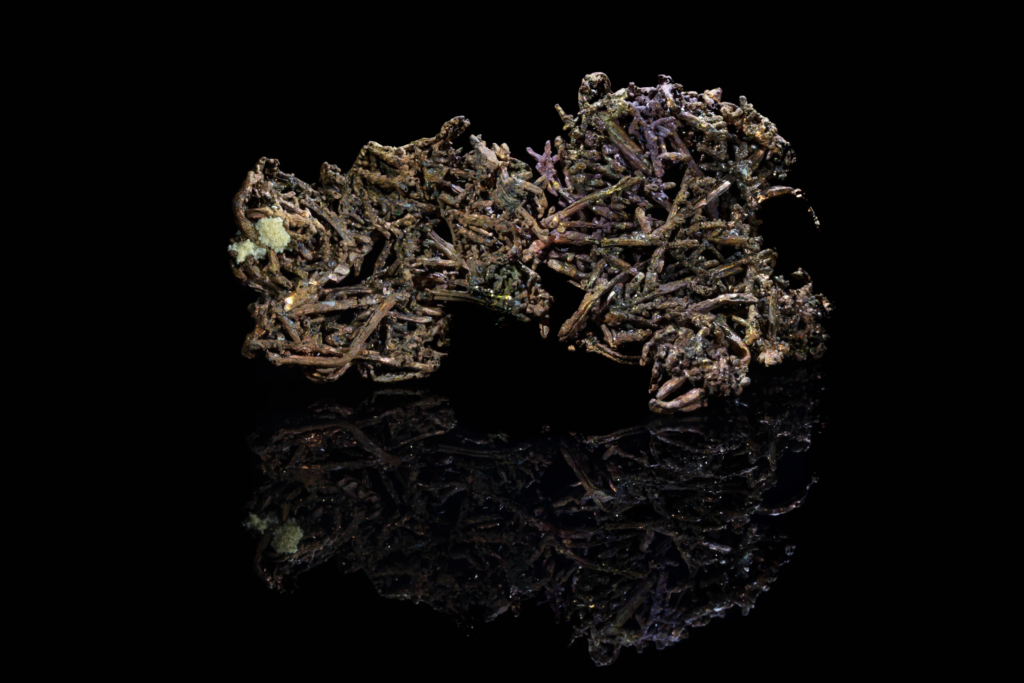 Dendritic native copper specimen from China against black background.