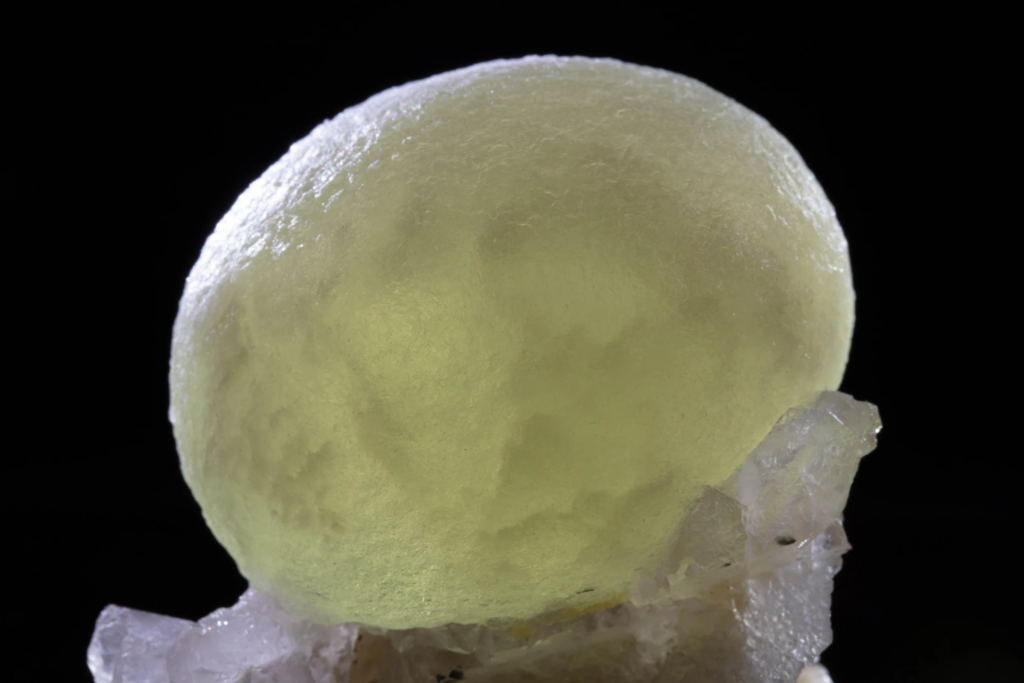 Mid-range view highlighting translucent yellow green spherical fluorite crystal texture.