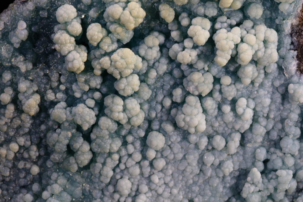 Macro view of cauliflower-like light blue gibbsite crystal aggregates.