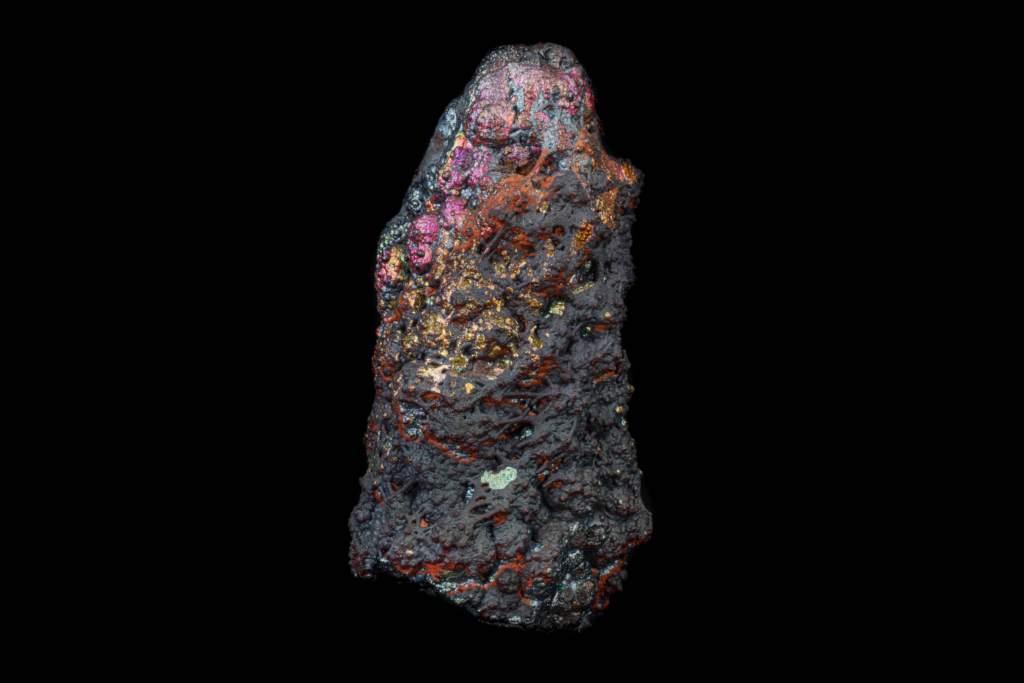 Elongated iridescent botryoidal goethite specimen from Spain against black.