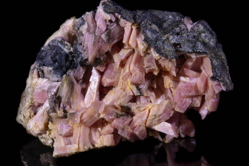 Front view of a blocky rose pink inesite mineral specimen.