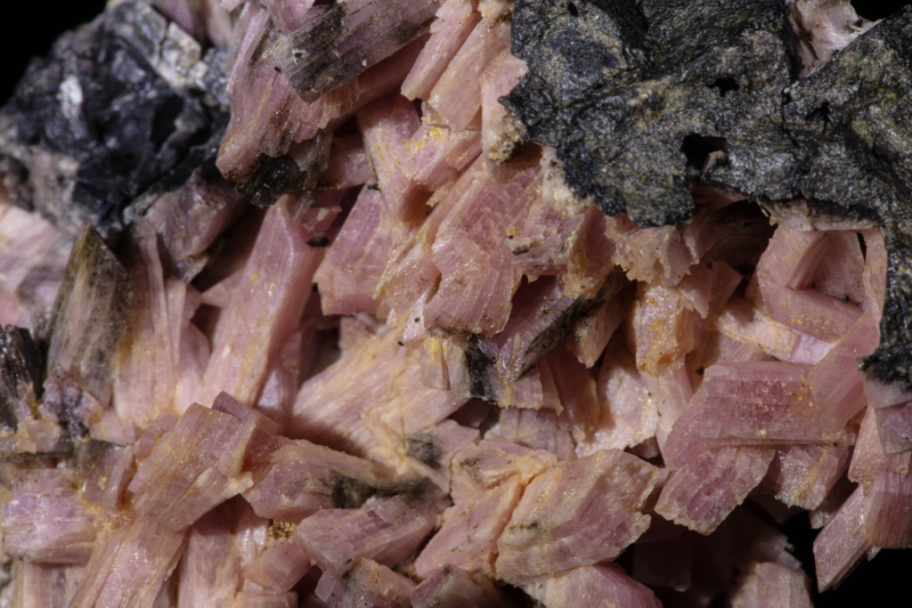 Macro snapshot showcasing the pearly luster of pink inesite needles.