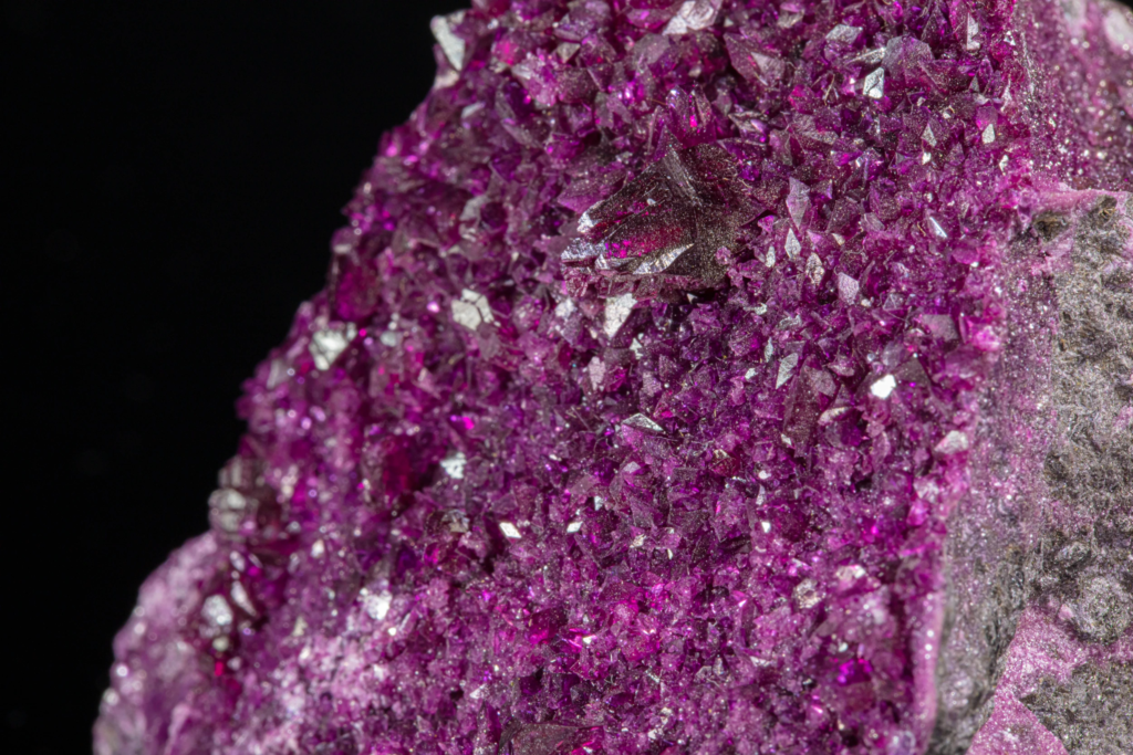 High magnification macro shot showcasing translucent magenta kammererite crystal faces.