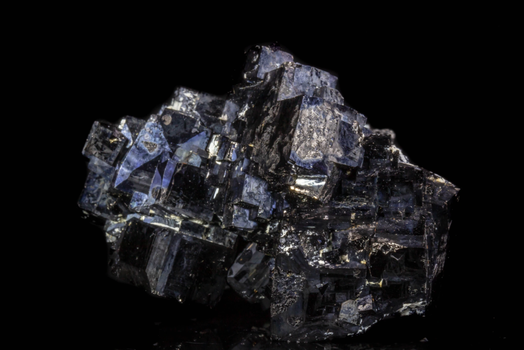 Close horizontal overview of interlocking iron black metallic magnetite crystals.