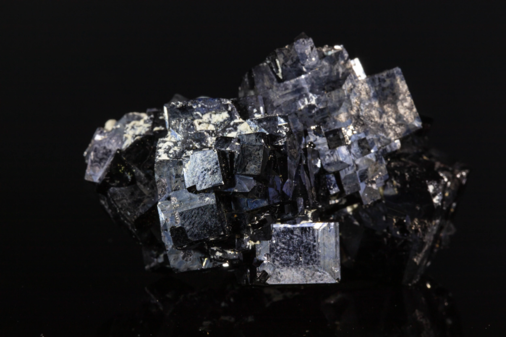 Close horizontal view showing reflective metallic faces of magnetite crystals.