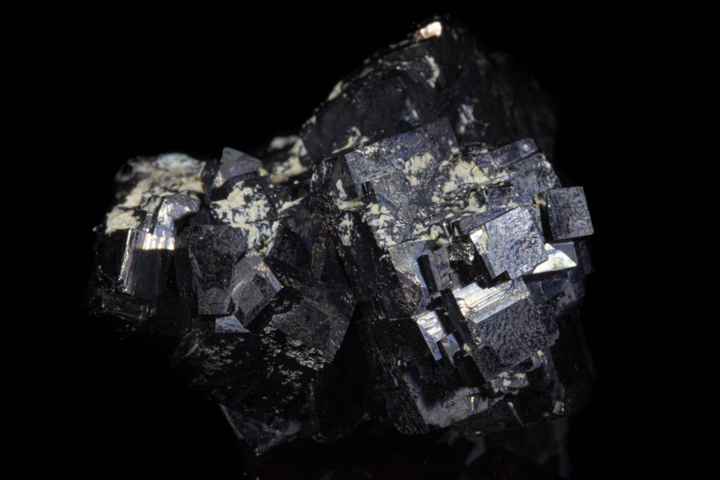 Detailed macro photograph capturing textured metallic black magnetite crystal faces.